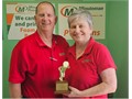 Minuteman Press Franchise Owners Jeff & Diana Merritt accept their Golden Minuteman Award at their center in Salisbury, MD.