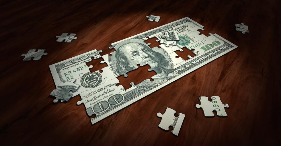Money broken into a puzzle piece to signify cash flow 