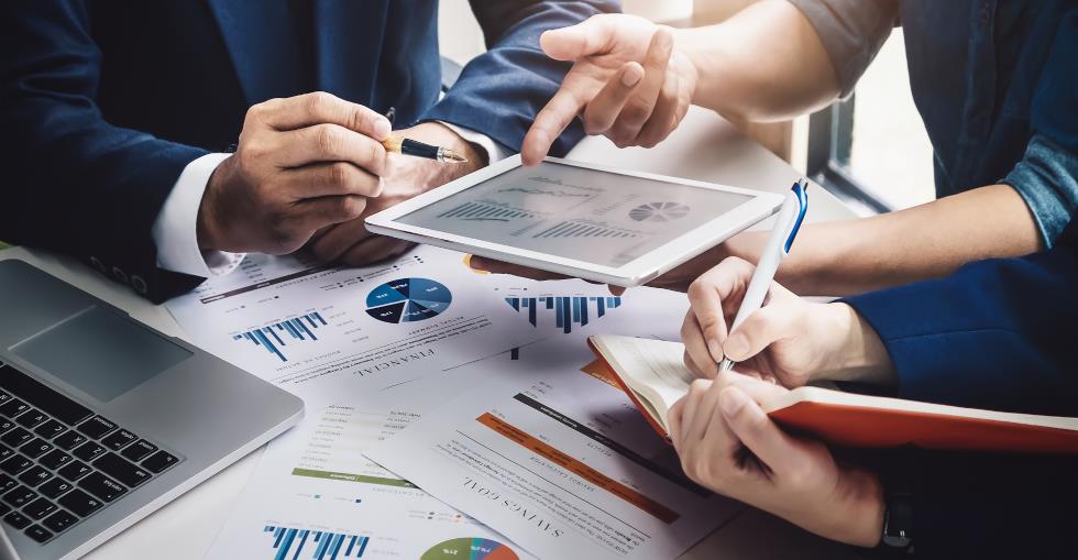 Business people discussing a range of financial documentation