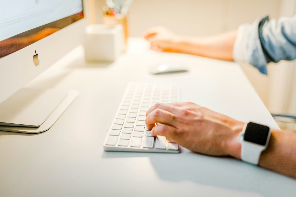 person typing on keyboard